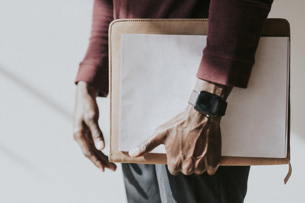 Man Holding A White Paper Mockup